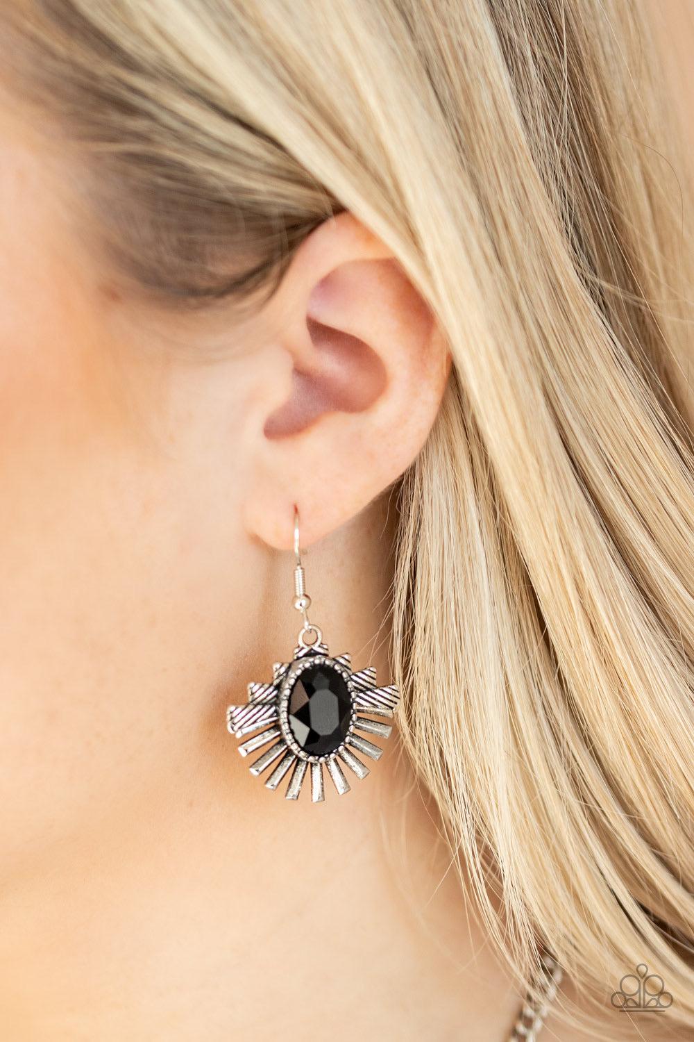 Paparazzi Accessories Miss YOU-niverse - Black Textured metal bars flare out from a mesmerizing black gem, creating a fringe of fanning frames. Sprinkled with white rhinestones, the dazzling display falls just below the collar for a sassy finish. Features