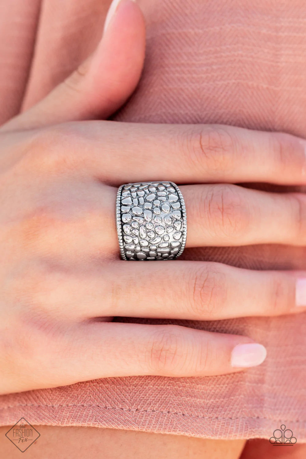 Paparazzi Accessories Dotted Decorum - Silver Brimming from edge to edge with a studded texture reminiscent of cobblestone, a wide silver band is bordered in dainty studs resulting in a free-spirited fashion atop the finger. Features a stretchy band for a