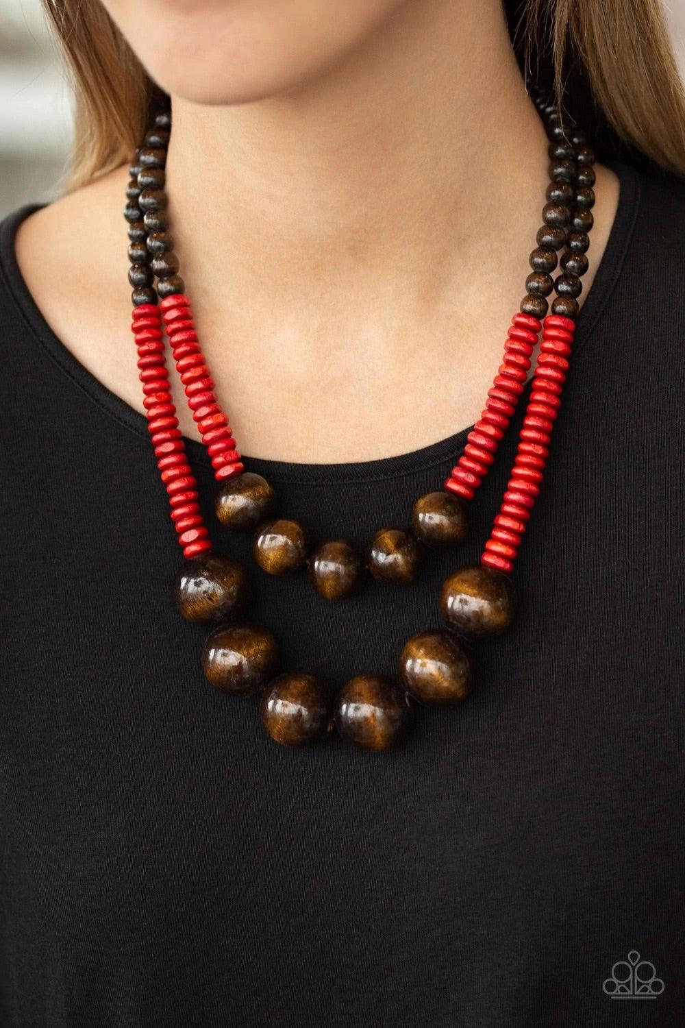 Paparazzi Accessories Cancun Cast Away - Red Earthy brown and fiery red wooden beads and discs are threaded along shiny strands of brown cording, creating colorful layers. Features a button loop closure. Sold as one individual necklace. Includes one pair