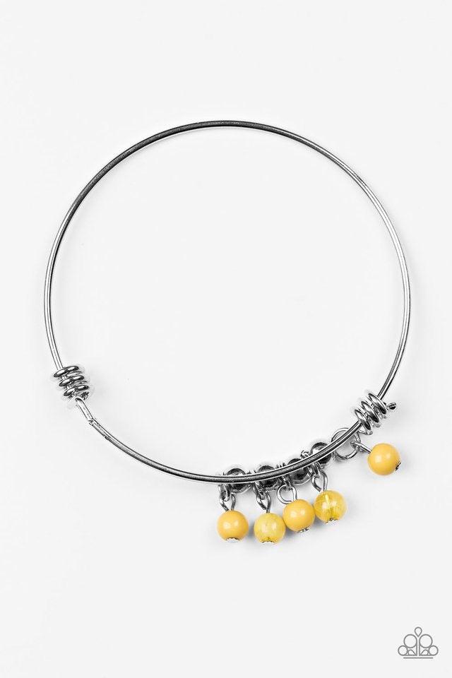Paparazzi Accessories All Roads Lead To ROAM - Yellow Silver wire coils around the wrist, creating an adjustable-like bangle. Glassy yellow beads slide between two wire wrap fittings, creating colorful accents along the wrist. Sold as one individual brace