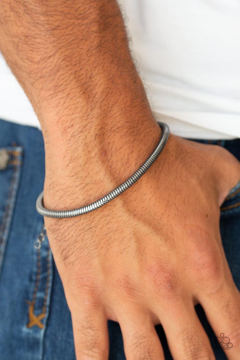Paparazzi Accessories Winning ~Black Brushed in a high-sheen shimmer, a rounded gunmetal snake chain links around the wrist for a sleek look. Features an adjustable clasp closure.
