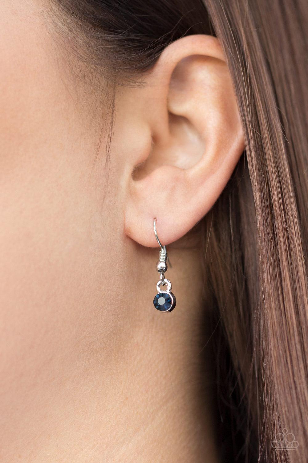 Paparazzi Accessories Spotlight Social - Blue Varying in size, an array of glittery white and blue rhinestones are encrusted along a shimmery silver hoop. The sparkling pendant swings from the bottom of an elongated silver chain for a glamorous finish. Fe