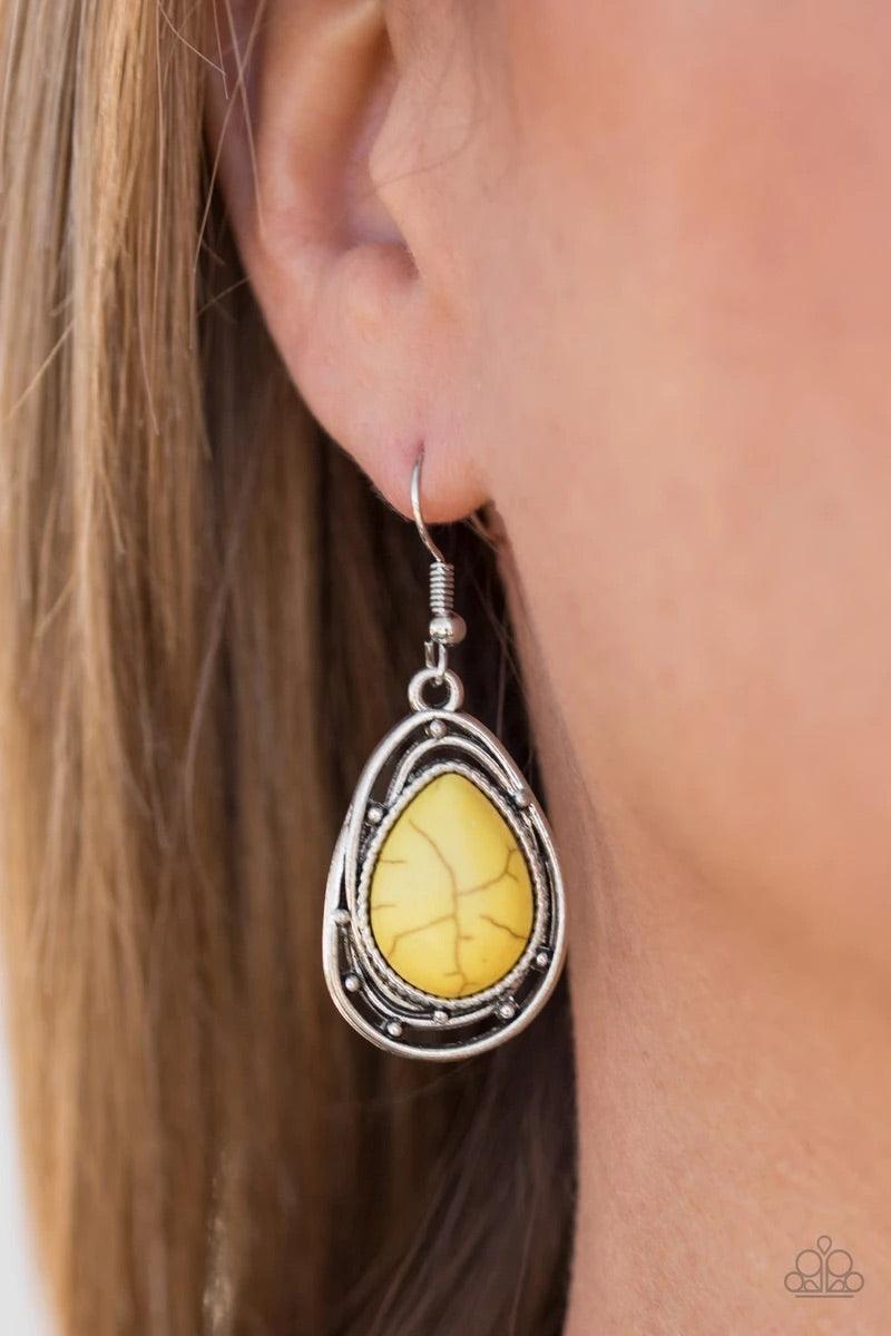 Paparazzi Accessories Abstract Anthropology - Yellow Chiseled into a tranquil teardrop, a sunny yellow stone is pressed into the center of a twisting silver frame for a handcrafted look. Earring attaches to a standard fishhook fitting. Sold as one pair of