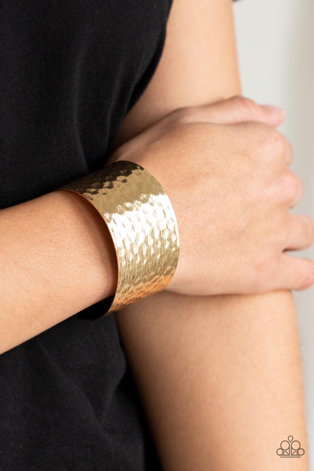Paparazzi Accessories Simmering Shimmer - Gold Delicately scratched and hammered in endless shimmer, a thick gold cuff wraps around the wrist for a bold industrial flair. Jewelry