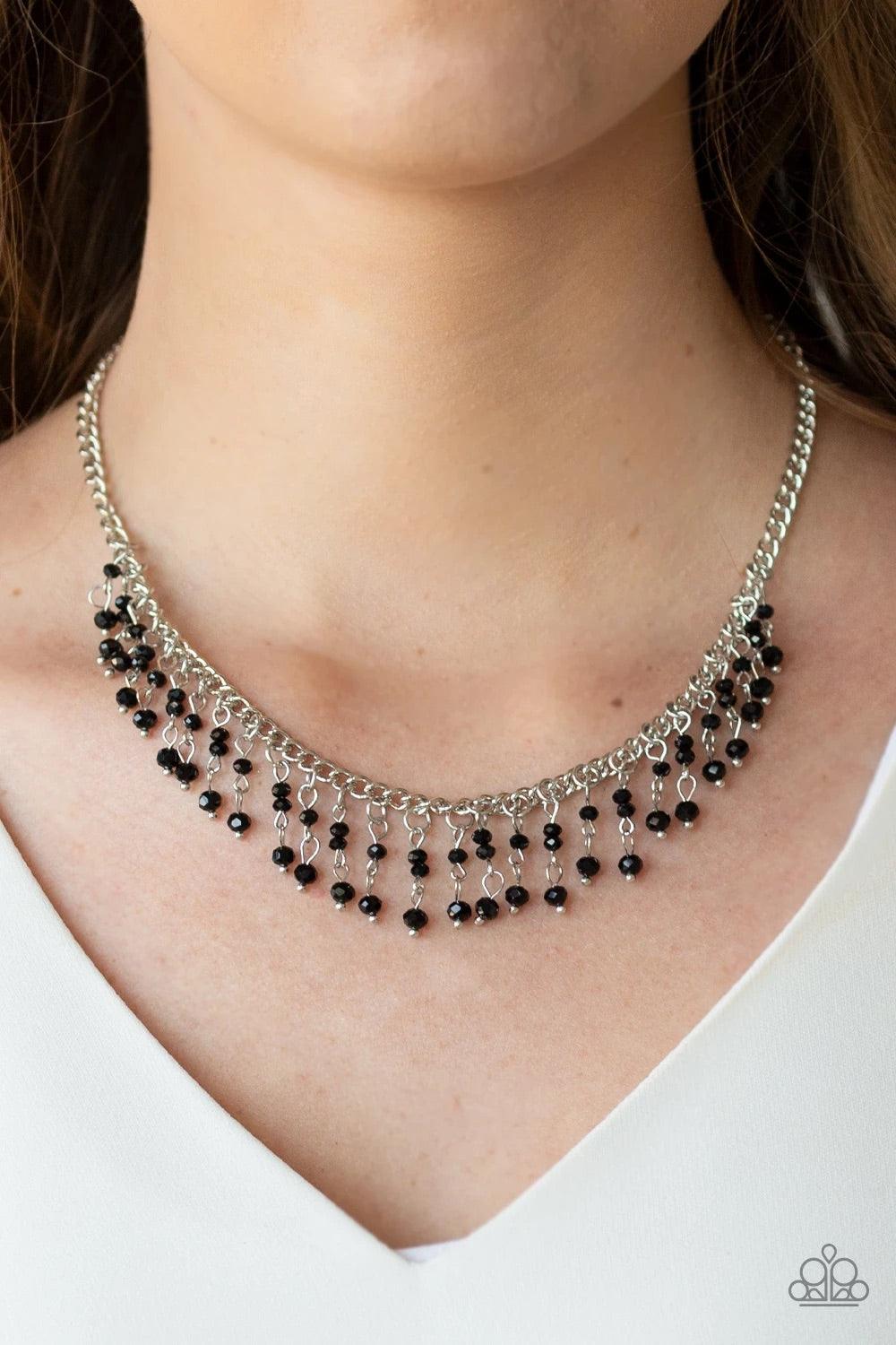 Paparazzi Accessories Sporadic Sparkle - Black A collection of dainty black crystal-like beads are threaded along stacks of metallic rods, creating a twinkling fringe below the collar. Features an adjustable clasp closure. Sold as one individual necklace.