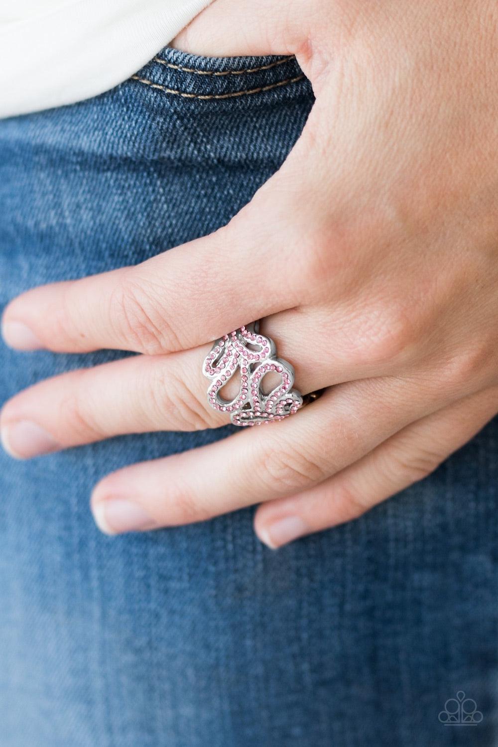 Paparazzi Accessories Dress Ir Up - Pink Ribbons of silver loop across the finger, creating a wavy band. Glittery pink rhinestones are sprinkled along swooping bands for a timeless finish. Features a stretchy band for flexible fit. Jewelry