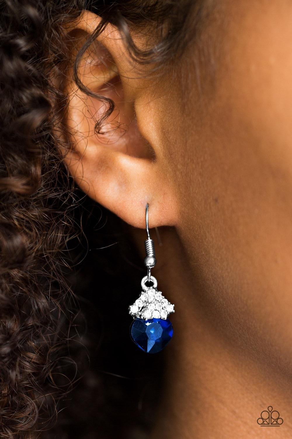 Paparazzi Accessories The Show Must GLOW On! - Blue Encrusted in glittery white rhinestones, shimmery silver frames stack atop a faceted blue gem for a dramatic look. Earring attaches to a standard fishhook fitting. Jewelry