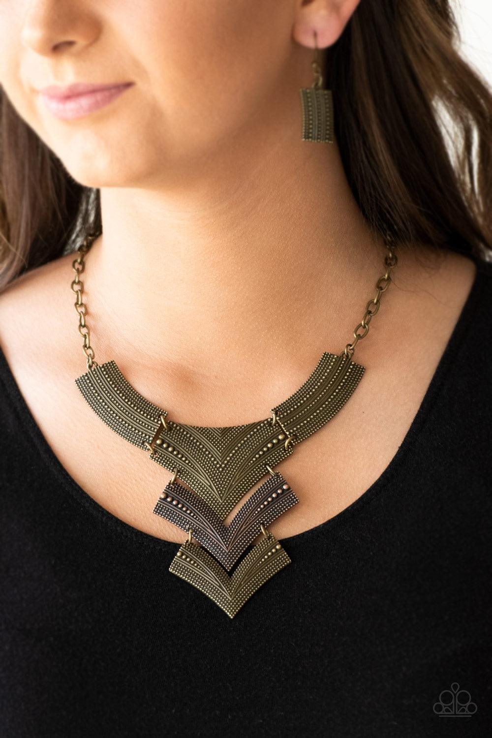 Paparazzi Accessories Fiercely Pharaoh - Multi Radiating in studded details, antiqued brass and copper plates link below the collar, joining into a fierce geometric pendant. Features an adjustable clasp closure. Sold as one individual necklace. Includes o