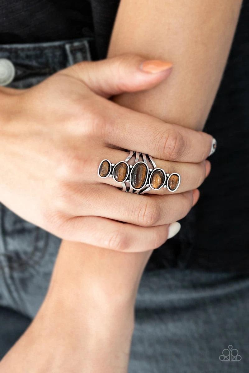 Paparazzi Accessories Stone Sublime - Brown Featuring imperfect silver frames, asymmetrical Tiger's Eye stones dramatically stack across the finger for an ethereal look. Features a stretchy band for a flexible fit. Sold as one individual ring. Jewelry