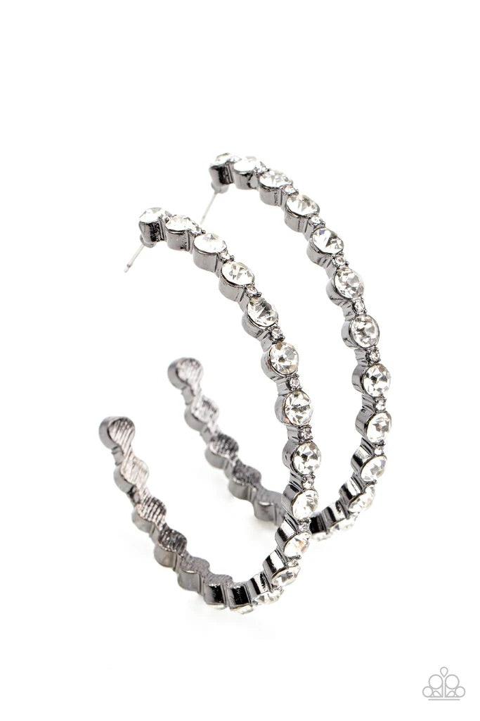 Paparazzi Accessories Royal Reveler - Black Encased in sleek gunmetal fittings, a glamorous collection of glittery white rhinestones delicately coalesce into an oversized hoop for a sparkly statement. Earring attaches to a standard post fitting. Hoop meas