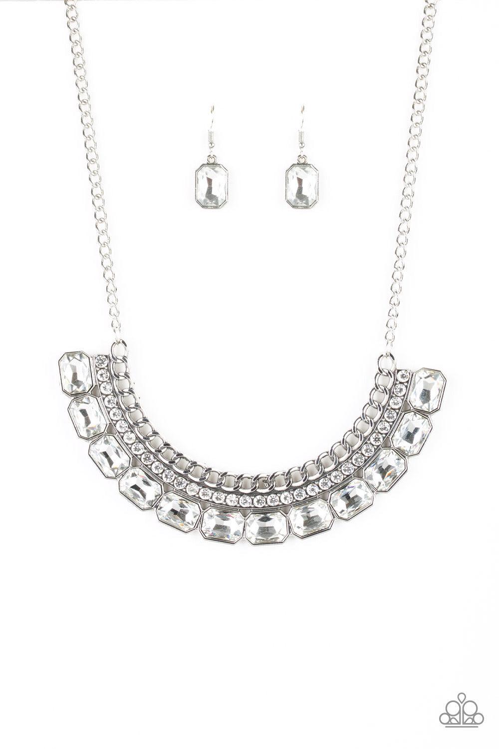 Paparazzi Accessories Killer Knockout - White Stationary rows of shimmery silver chain, glittery white rhinestones, and glassy white emerald-cut gems coalesce into a bold pendant below the collar. Features an adjustable clasp closure. Jewelry