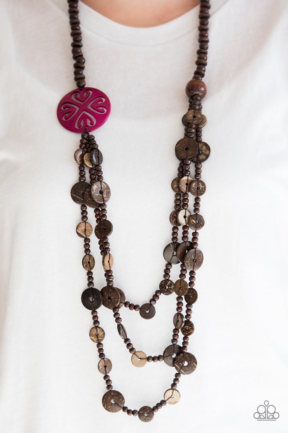 Paparazzi Accessories Jungle Jive - Pink Mismatched brown wooden beads are threaded along a shiny brown string, creating summery layers across the chest. Featuring a whimsical floral pattern, a dramatic pink wooden bead adorns one side for a seasonal fini