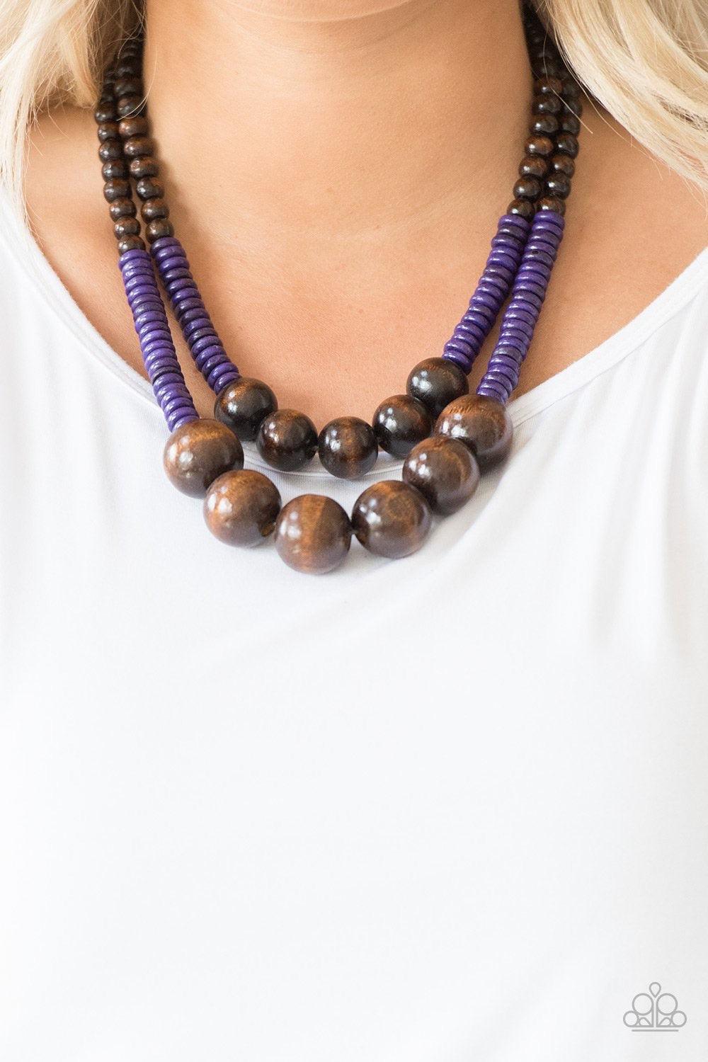 Paparazzi Accessories Cancun Cast Away - Purple Earthy brown and vivacious purple wooden beads and discs are threaded along shiny strands of brown cording, creating colorful layers. Features a button loop closure. Jewelry