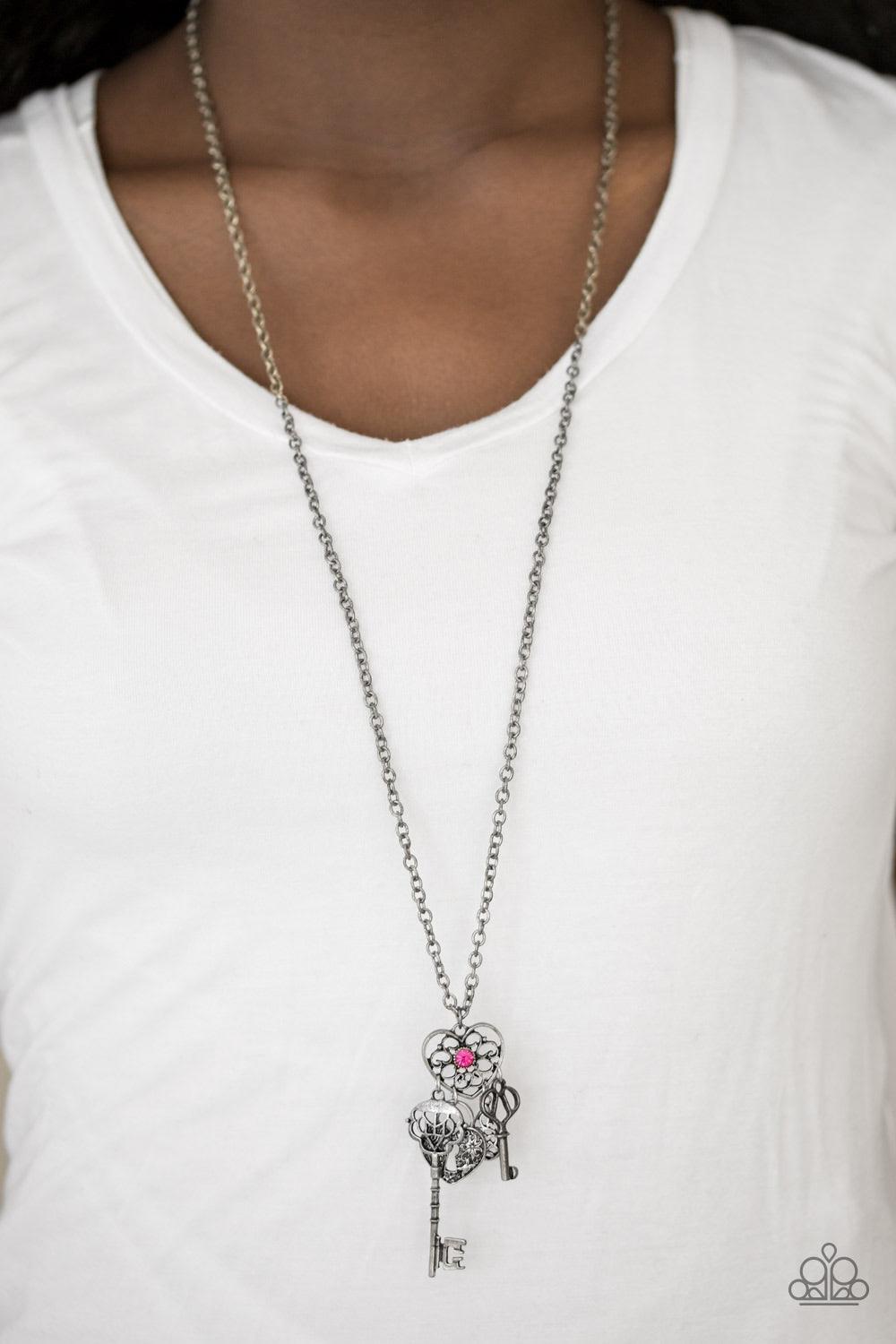 Paparazzi Accessories Secret of the Hearts - Pink Brushed in an antiqued silver shimmer, an ornate teardrop, heart-shaped lock, and two keys swing from the bottom of a vintage inspired heart pendant, creating a whimsical tassel. A dainty pink rhinestone i