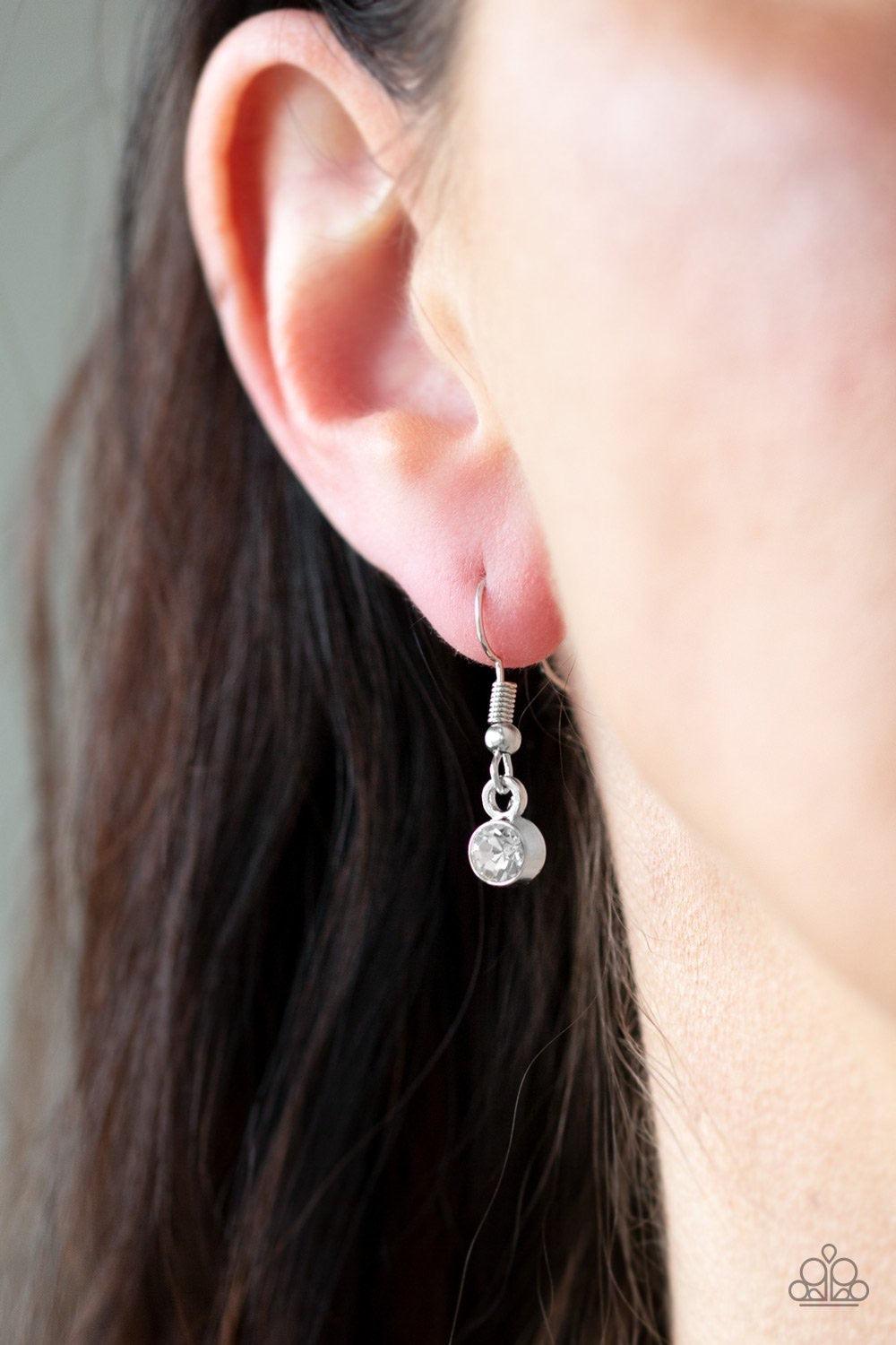 Paparazzi Accessories Special Treatment - White A collection of round and teardrop white rhinestones coalesce into a bowing silver pendant below the collar for a refined look. Features an adjustable clasp closure. Jewelry