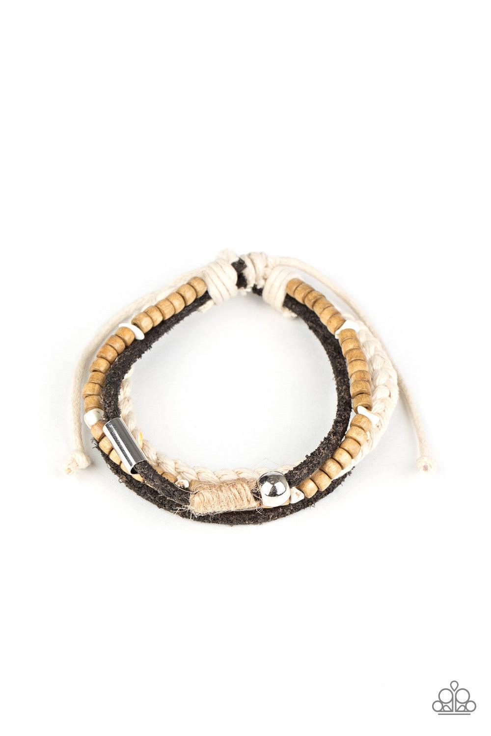 Paparazzi Accessories Sahara Pilgrim - Black Featuring silver, stone, and wooden beaded accents, a mismatched collection of suede and twine-like braided bands layer across the wrist for an earthy look. Features an adjustable sliding knot closure. Sold as