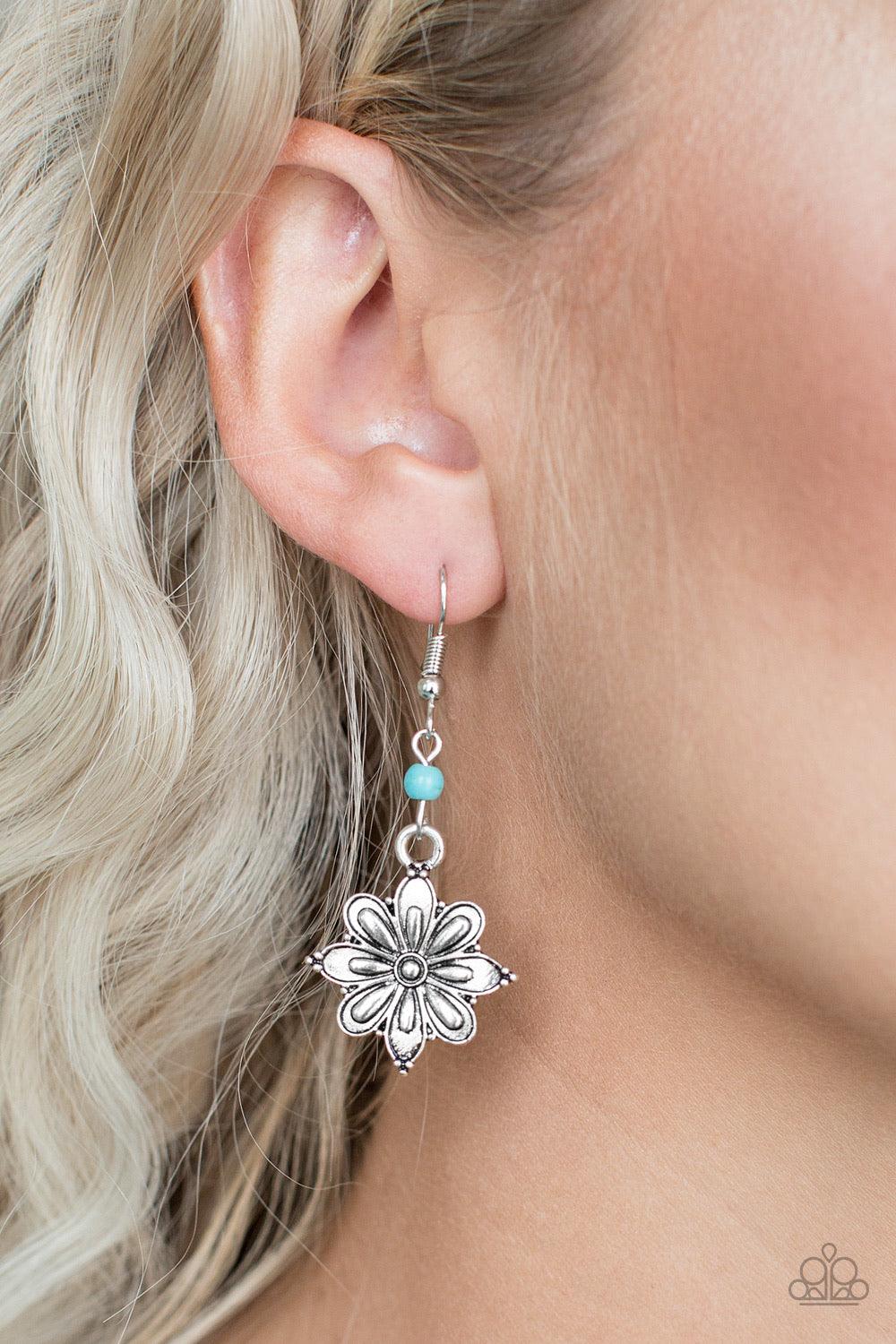 Paparazzi Accessories Cactus Blossom - Blue Brushed in a high-sheen finish, a glistening silver flower frame swings from the bottom of a dainty turquoise stone for a seasonal look. Earring attaches to a standard fishhook fitting. Jewelry