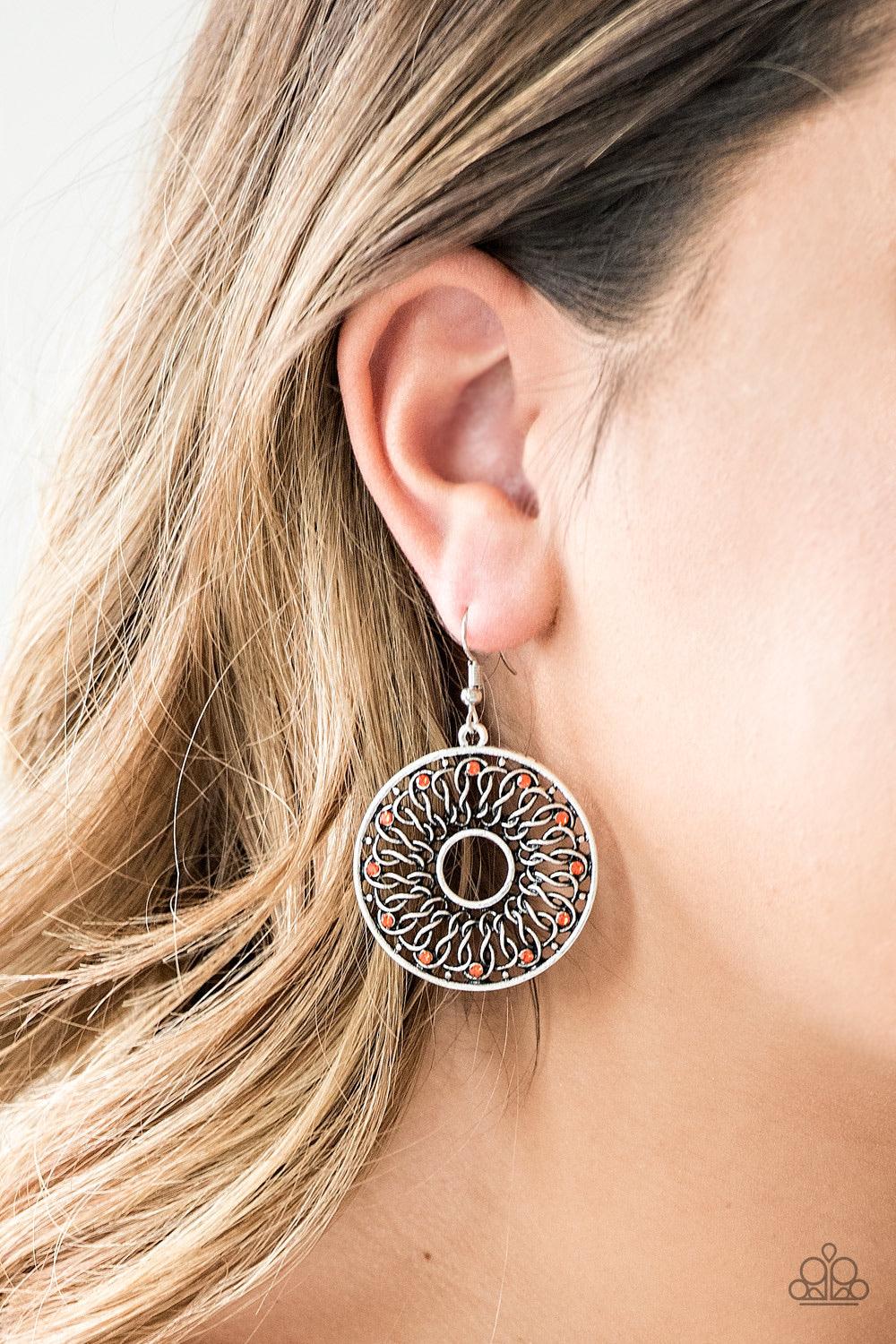 Paparazzi Accessories Malibu Musical - Orange Dotted in dainty orange rhinestones, glistening silver wires twist and interlock inside of a shimmery silver hoop for a whimsical look. Earring attaches to a standard fishhook fitting Jewelry
