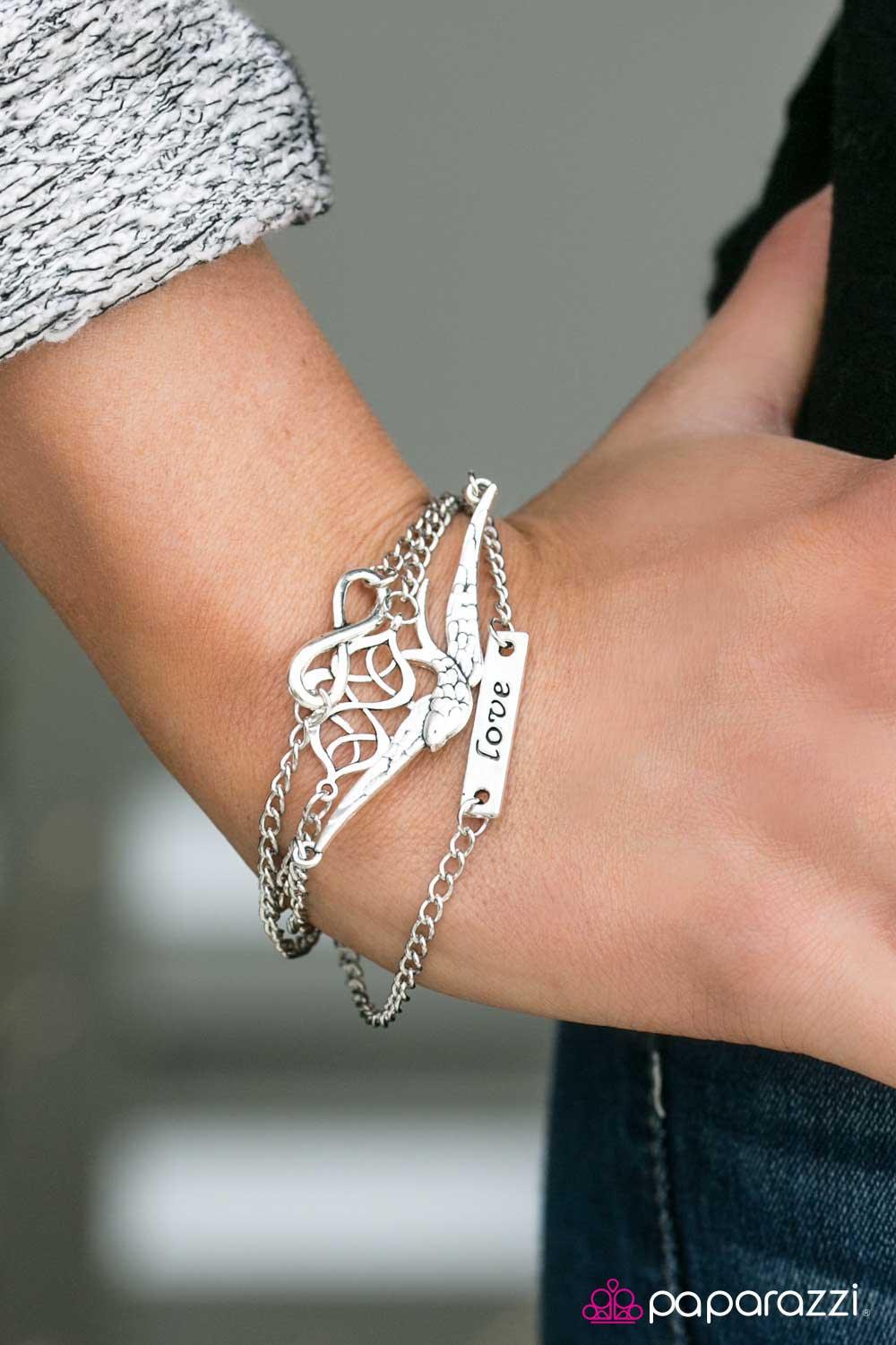 Paparazzi Accessories Then Love Swooped In - Silver Four layers of silver chain are embellished with silver charms. Charms include a textured bird, an infinity sign, a filigree-swirled fitting and a rectangular silver plate with the word "love" etched int