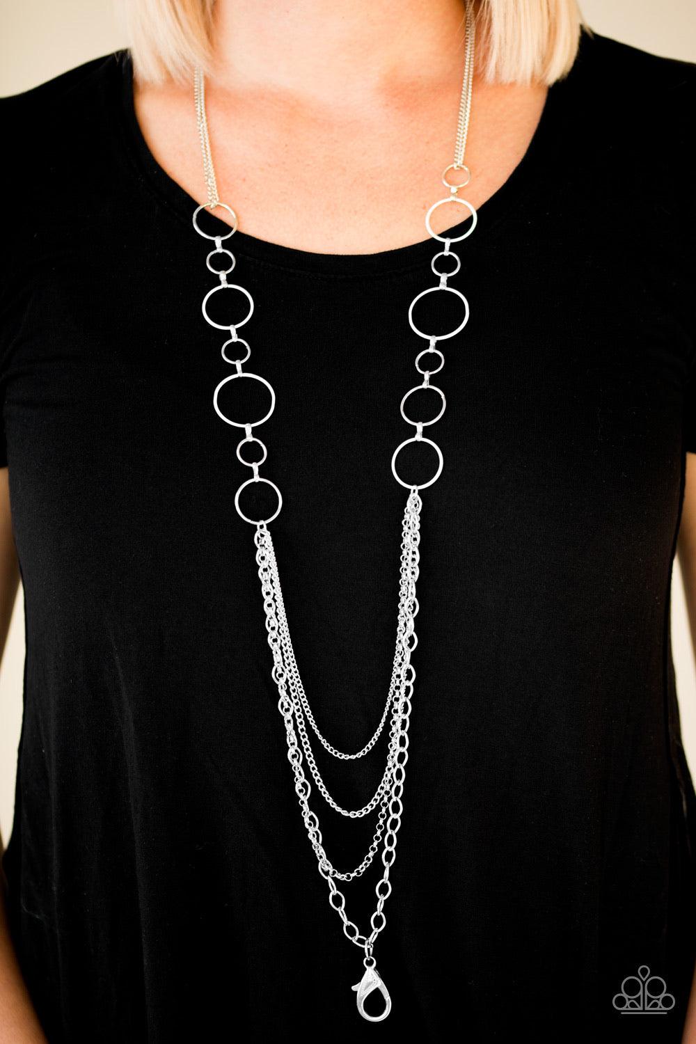 Paparazzi Accessories Industrial Circus - White *Lanyard Neutral white and shiny silver hoops give way to layers of mismatched silver chain for an edgy look. A lobster clasp hangs from the bottom of the design to allow a name badge or other item to be att