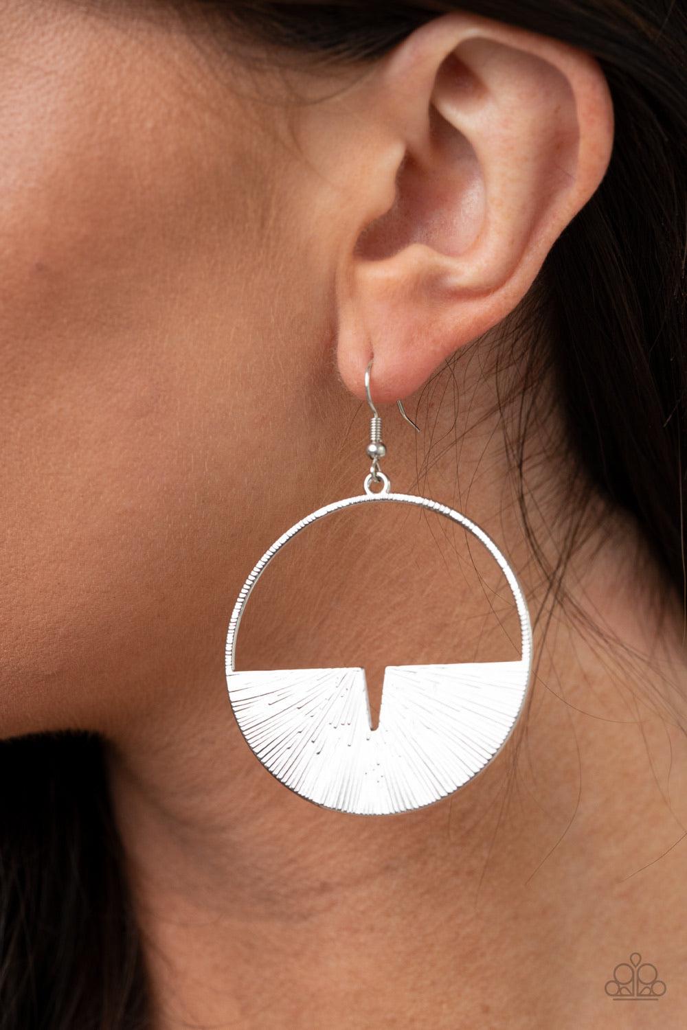 Paparazzi Accessories Reimagined Refinement - Silver Embossed in radiant linear textures, a crescent silver frame is nestled along the bottom of a textured silver hoop for an edgy look. Earring attaches to a standard fishhook fitting. Sold as one pair of