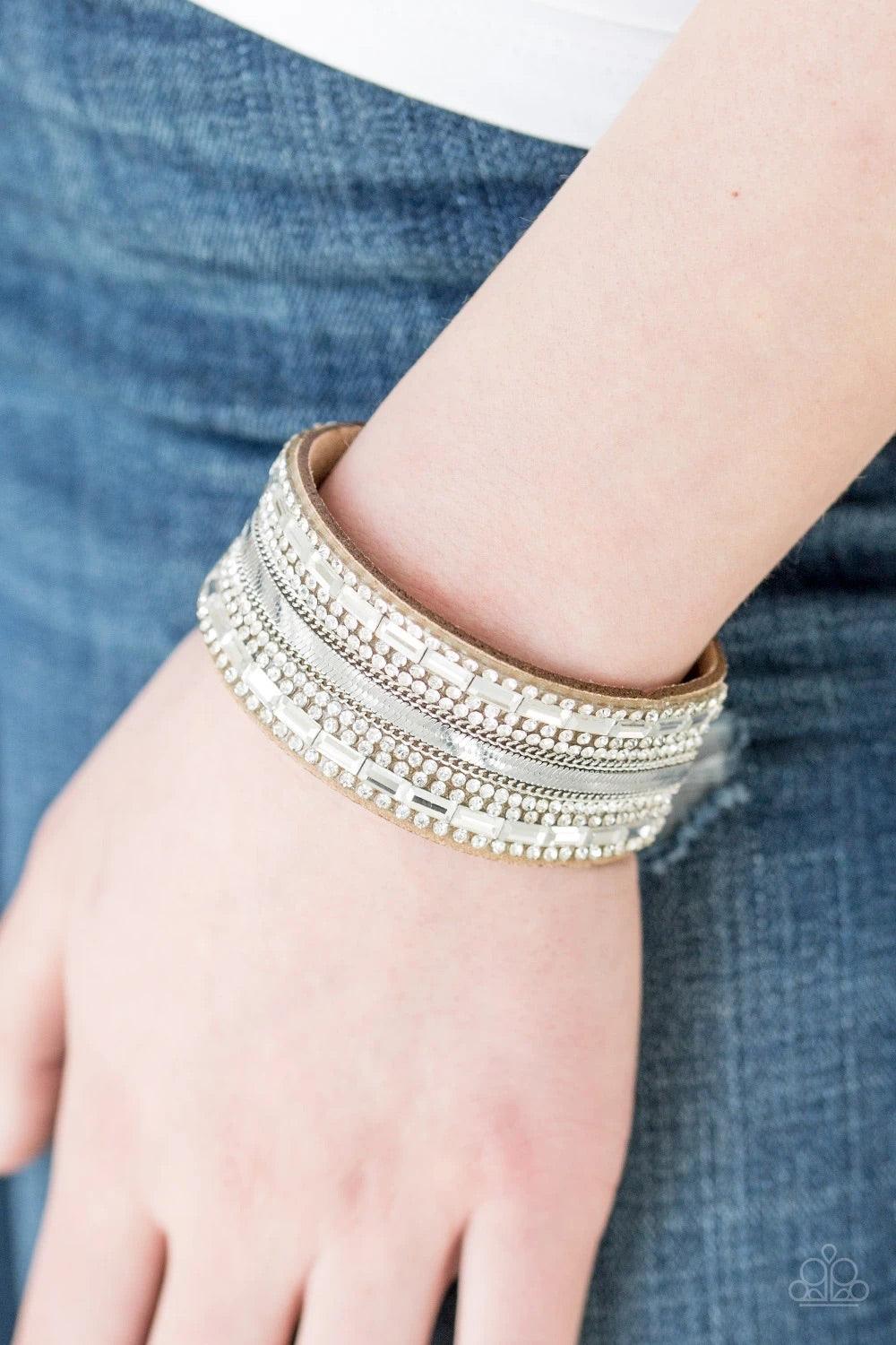 Paparazzi Accessories Teasingly Tomboy - Brown Mismatched silver chains, glassy emerald-cut, and glittery white rhinestones are encrusted along a thick brown suede band for a sassy look. Features an adjustable snap closure. Sold as one individual bracelet
