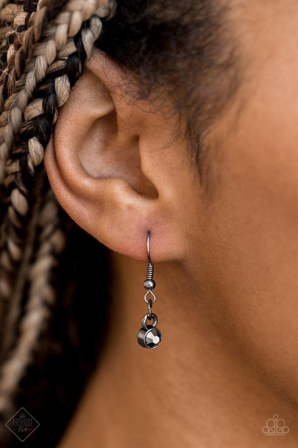 Paparazzi Accessories Razzle Dazzle - Black Featuring mismatched gunmetal black chains, a studded black pendant is encrusted in glittery black rhinestones and hangs below the collar for a dramatic industrial look. Features an adjustable clasp closure. Jew
