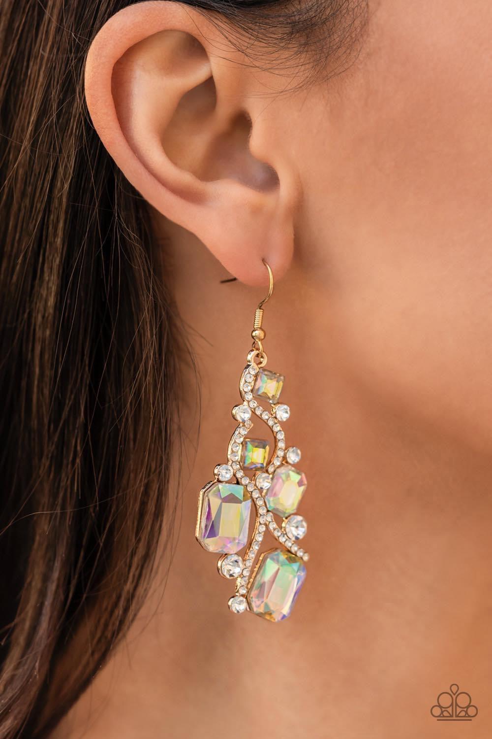 Paparazzi Accessories Interstellar Illumination- Multi Golden ribbons of glassy white rhinestones whirl around a chandelier of classic round white rhinestones and emerald and square cut iridescent rhinestones, coalescing into an effervescent elegance. Ear