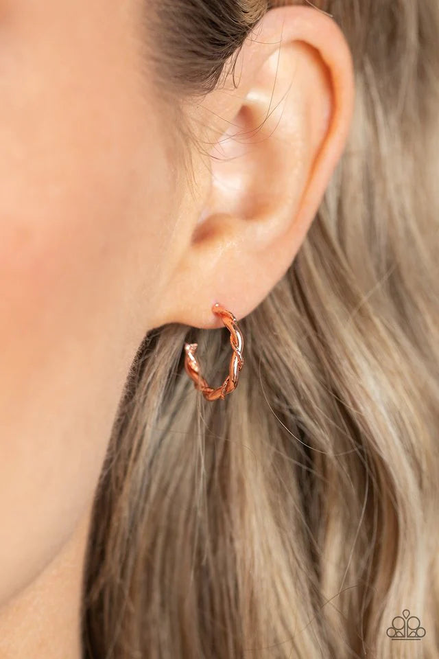Paparazzi Accessories Irresistibly Intertwined - Copper A mismatched pair of shiny copper wires delicately twists into a classic hoop, creating a dainty peek of shimmer. Earring attaches to a standard post fitting. Hoop measures approximately 1/2" in diam