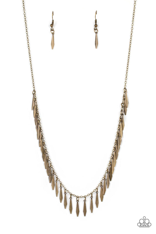 Paparazzi Accessories Striking Sheen - Brass Dainty brass bars with a subtle curvature along their center, dance vivaciously along a brass chain to create a fierce fringe along the neckline. Each brass bar is flared at the bottom, expanding its light-catc