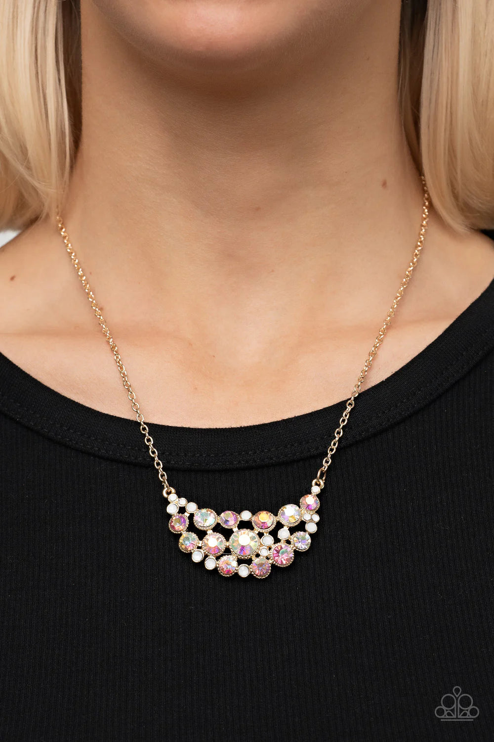 Paparazzi Accessories Effervescently Divine - Gold An effervescent collection of opal and iridescent rhinestones delicately join into a bubbly half moon pendant at the bottom of a dainty gold chain, resulting in a sparkly statement piece below the collar.