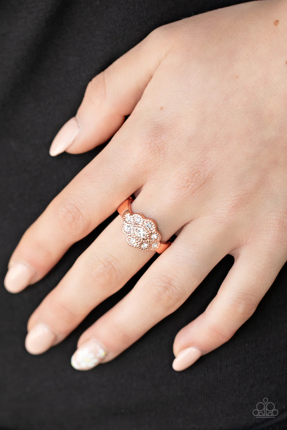 Paparazzi Accessories Floral Frou- Frou - Copper Dainty white rhinestones dot the front of a studded shiny copper floral frame, creating a glitzy centerpiece atop the finger. Features a dainty stretchy band for a flexible fit. Sold as one individual ring.