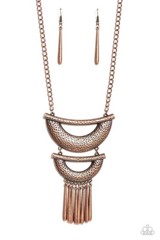 Paparazzi Accessories Fringe Festival - Copper Hammered in textured detail, two oversized copper half moon plates connect down the chest, creating a fiercely stacked pendant. Antiqued copper rods swing from the bottom of the lowermost plate, creating an e