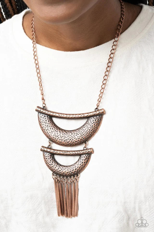 Paparazzi Accessories Fringe Festival - Copper Hammered in textured detail, two oversized copper half moon plates connect down the chest, creating a fiercely stacked pendant. Antiqued copper rods swing from the bottom of the lowermost plate, creating an e