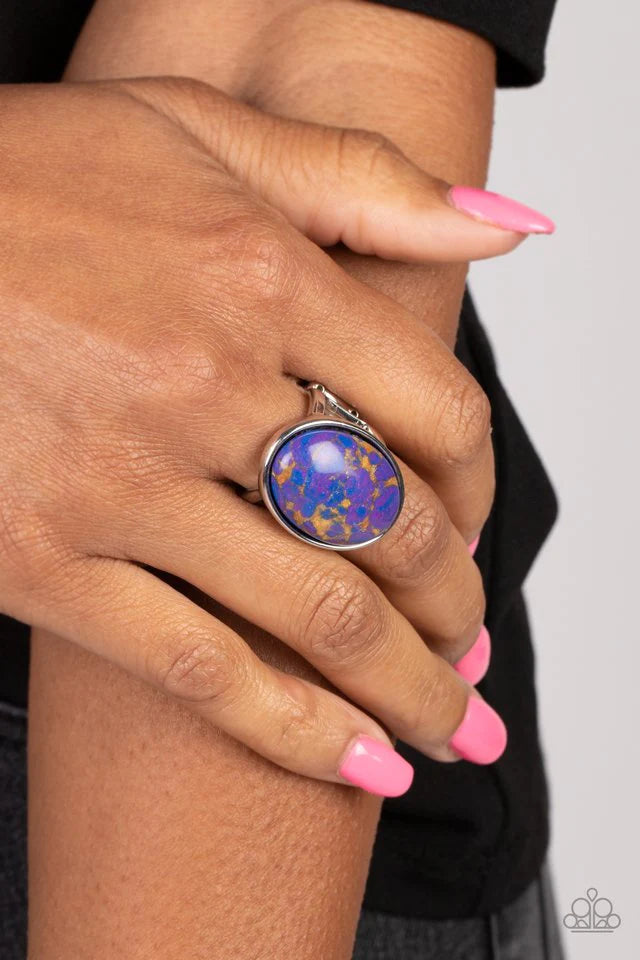 Paparazzi Accessories Majestic Marbling - Purple Featuring a colorful marble finish, a speckled purple stone is pressed into the center of a silver oval frame for a modern look. Features a stretchy band for a flexible fit. Sold as one individual ring. Jew