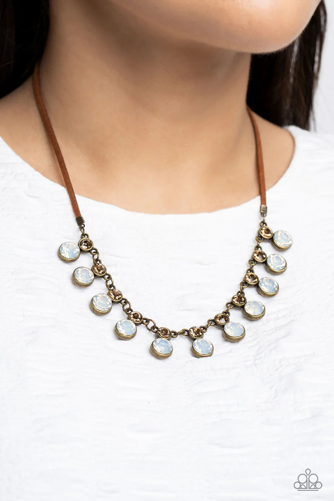 Paparazzi Accessories Color Me Chic - Brass A collection of oversized, opalescent rhinestones, set in brass frames attaches to a collection of topaz rhinestones set in similar frames. Strung along a brass chain, the sparkly collection attaches to a strand