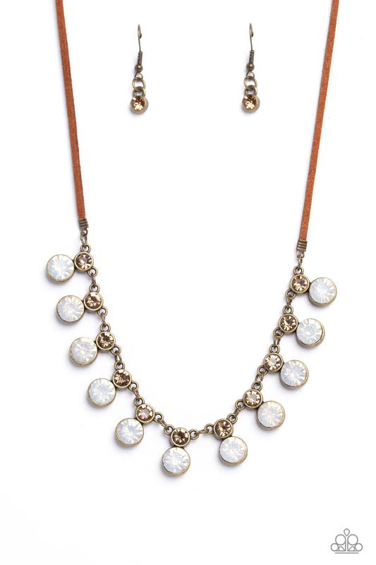 Paparazzi Accessories Color Me Chic - Brass A collection of oversized, opalescent rhinestones, set in brass frames attaches to a collection of topaz rhinestones set in similar frames. Strung along a brass chain, the sparkly collection attaches to a strand