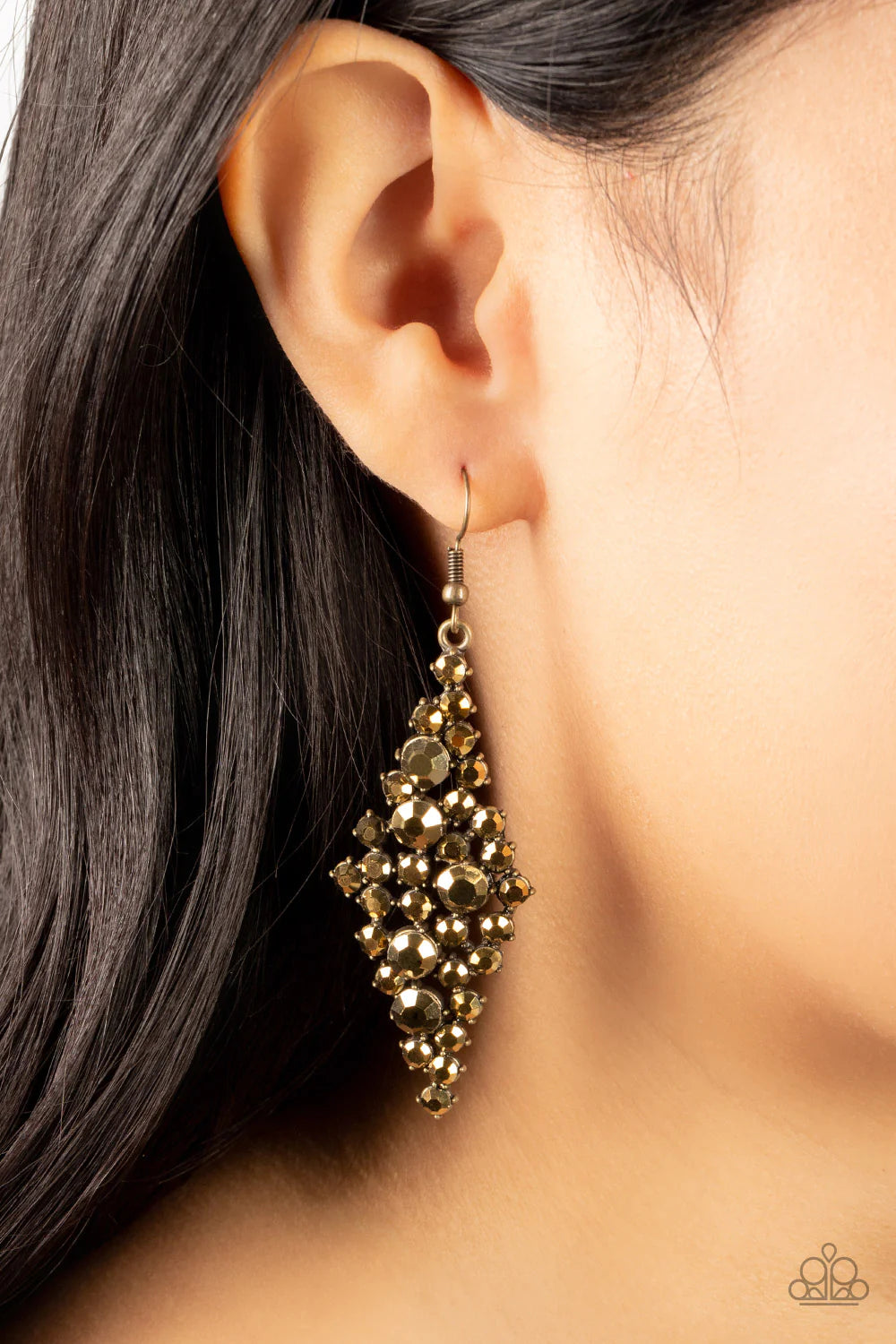 Paparazzi Accessories Celestial Comet - Brass Encased in pronged brass fittings, a mismatched collection of gritty aurum rhinestones tumble into a clustered lure for a smoldering shimmer. Earring attaches to a standard fishhook fitting. Sold as one pair o