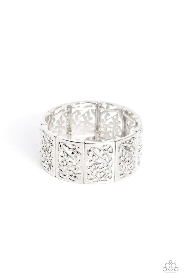 Paparazzi Accessories Garden Walls - White Sleek silver frames, filled with whimsical leafy floral filigree and opalescent, white, and iridescent rhinestones, stack around the wrist on an elastic stretchy band for a dainty handcrafted statement. Due to it