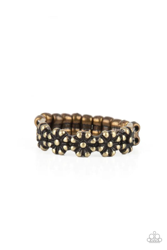 Paparazzi Accessories Farmhouse Fashion - Brass An antiqued collection of brass studs delicately coalesce into a dainty band of daisies across the finger, creating a rustic centerpiece. Features a dainty stretchy band for a flexible fit. Sold as one indiv