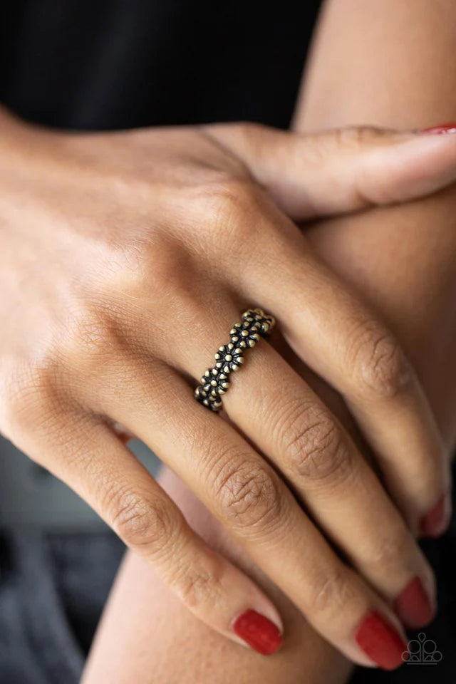Paparazzi Accessories Farmhouse Fashion - Brass An antiqued collection of brass studs delicately coalesce into a dainty band of daisies across the finger, creating a rustic centerpiece. Features a dainty stretchy band for a flexible fit. Sold as one indiv