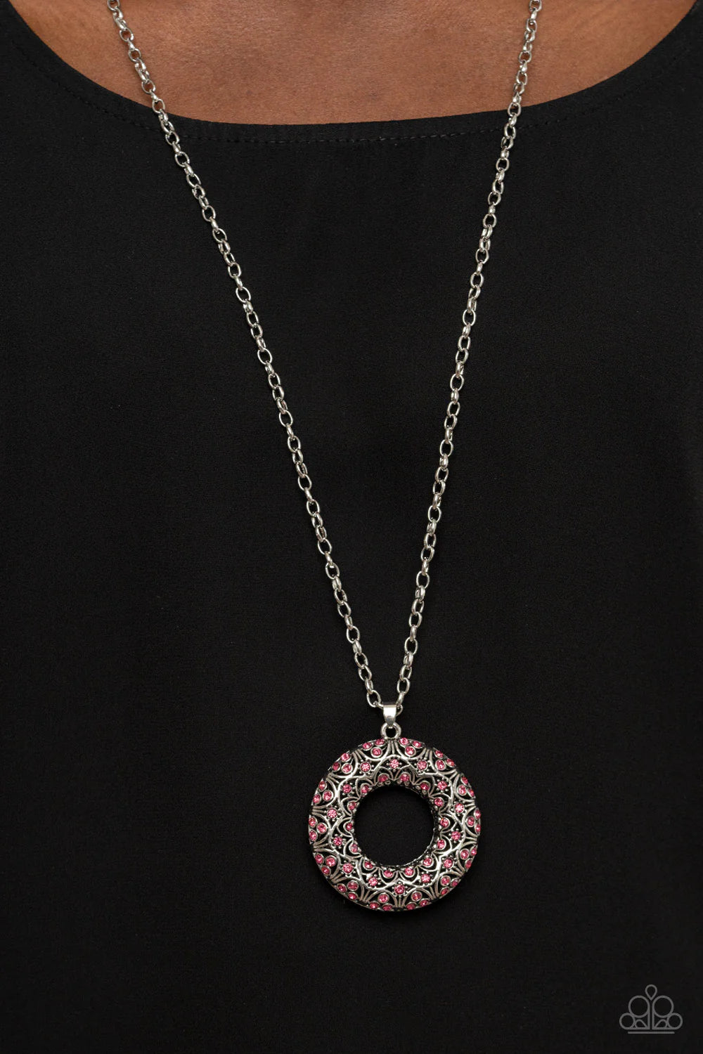 Paparazzi Accessories Wintry Wreath - Pink Dotted with glittering pink rhinestones and filled with frilly silver filigree accents, an oversized silver wreath sparkles from the bottom of an extended silver chain for a whimsical fashion. Features an adjusta