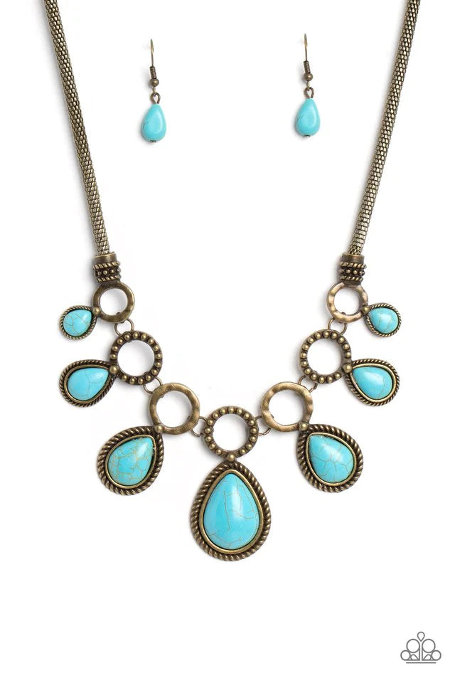 Paparazzi Accessories Riverside Relic - Brass An airy mesh chain gives way to a collection of brass rings that link along the collar. A rustic dot motif decorates three of the rings, alternating with the remaining hoops that feature a subtle hammered text