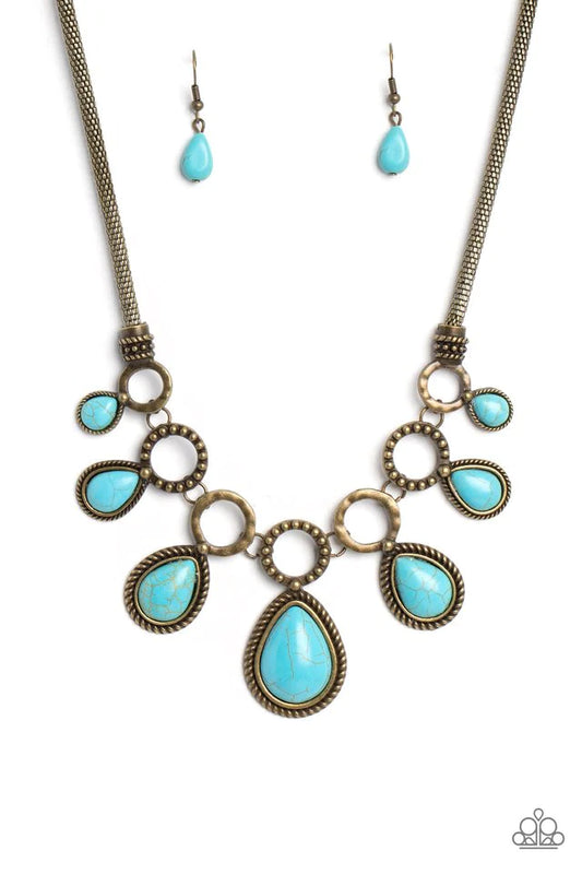 Paparazzi Accessories Riverside Relic - Brass An airy mesh chain gives way to a collection of brass rings that link along the collar. A rustic dot motif decorates three of the rings, alternating with the remaining hoops that feature a subtle hammered text