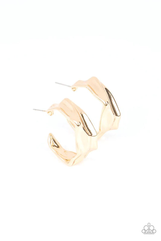 Paparazzi Accessories Cutting Edge Couture - Gold Featuring faceted edges, a warped gold frame curves into an asymmetrical hoop for an intense industrial flair. Earring attaches to a standard post fitting. Hoop measures approximately 1 1/4" in diameter Je