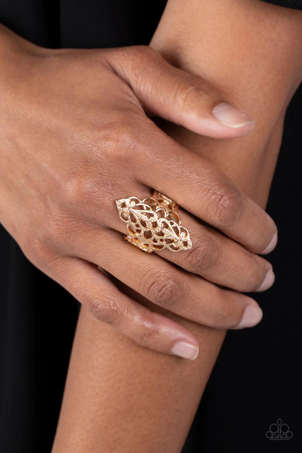 Paparazzi Accessories Curled Crown - Gold Shiny gold filigree curls into a marquise-shaped display atop the finger. The stenciled design allows the skin to peek beneath the airy pattern for a regal finish. Features a stretchy band for a flexible fit. Sold