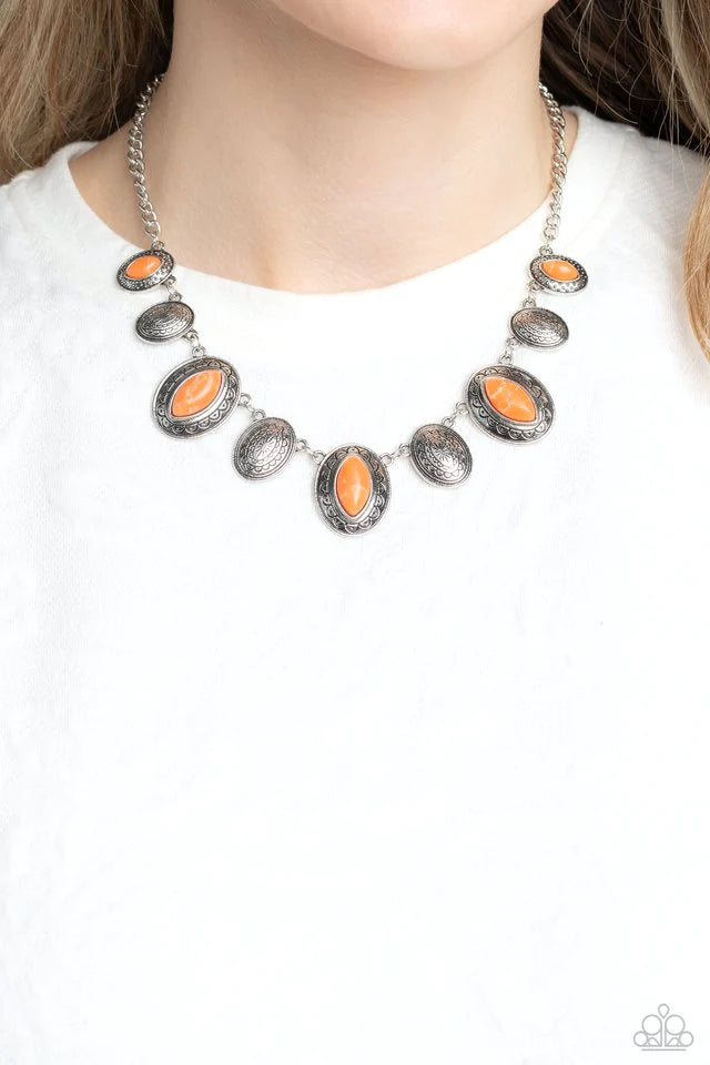 Paparazzi Accessories Textured Trailblazer - Orange Silver oval discs in varying sizes are inscribed with earthy patterns and studs as they coalesce around the collar on a classic silver chain. Pressed into every other disc, a marquise-chiseled orange sto
