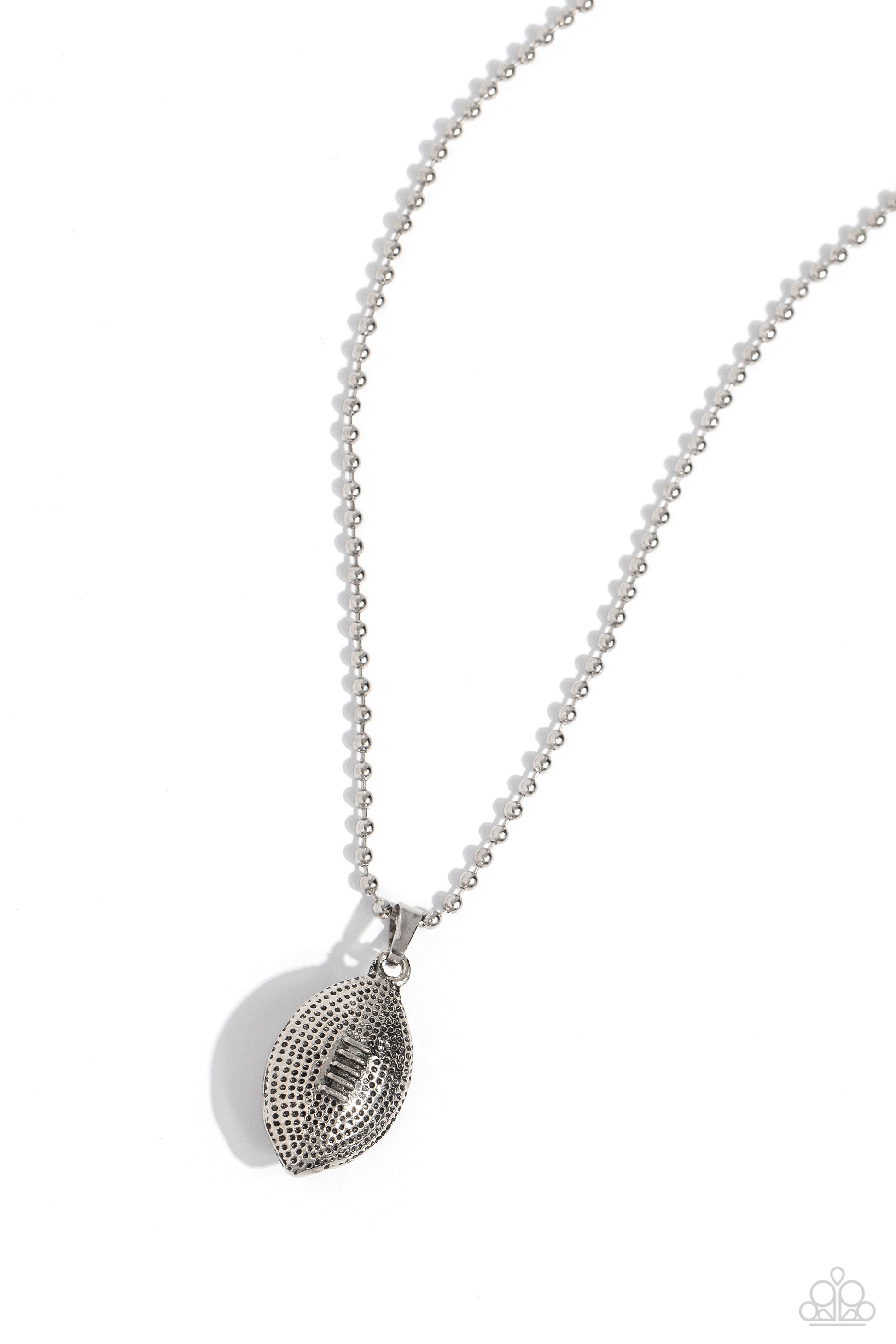 Paparazzi Accessories Timeless Tackle - Silver Featuring a dot motif, a thick silver football pendant glides along a silver ball chain for a touchdown tribute. Features an adjustable clasp closure. Sold as one individual necklace. Includes one pair of mat