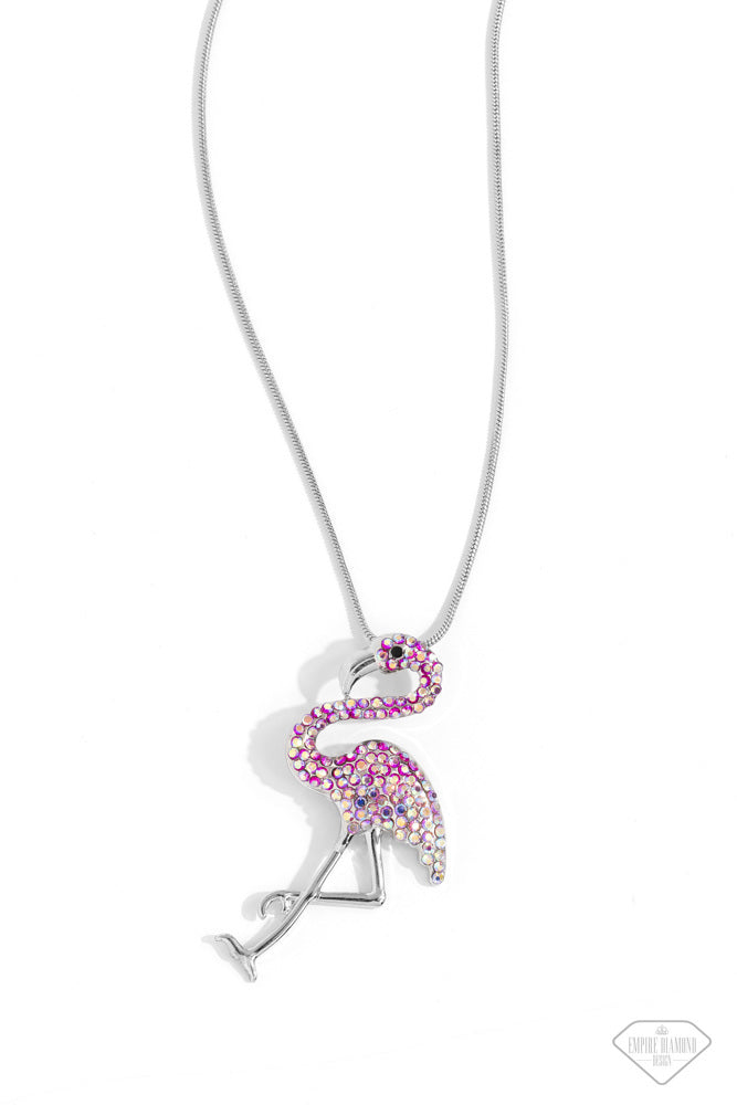 Paparazzi Accessories Flamingo Finesse - Pink Featuring an ombré effect of fuchsia iridescent rhinestones to light pink iridescent rhinestones, a flamingo charm with a silver beak, silver legs, and a black beaded eye, glides along a sleek silver snake cha
