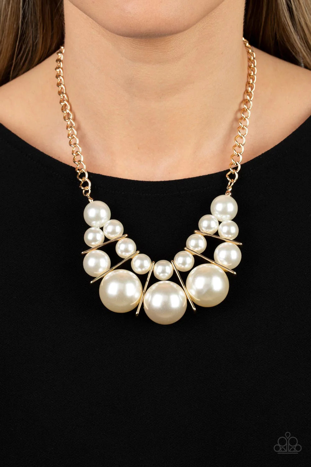 Paparazzi Accessories Challenge Accepted - Gold Separated by rectangular gold frames, bubbly rows of classic and oversized white pearls are threaded along invisible wires at the bottom of a chunky gold chain for an effervescent explosion below the collar.